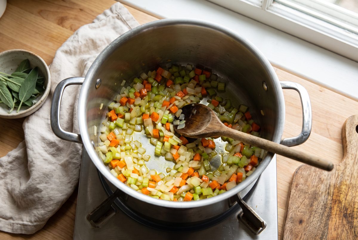 Diced onion, carrot and celery softening in olive oil in a large pot